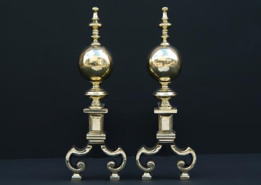 A pair of brass firedogs with ball finials