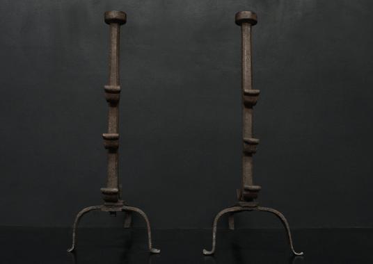 A pair of wrought iron firedogs