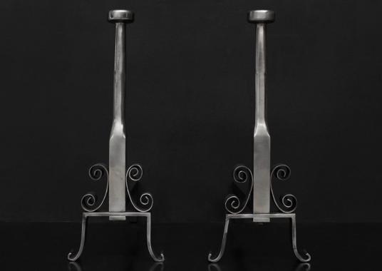 A pair of English polished steel firedogs