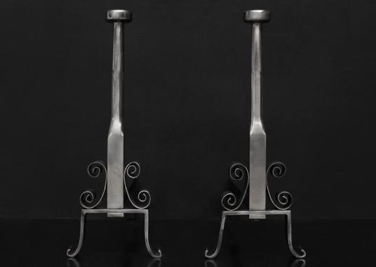 A pair of English polished steel firedogs