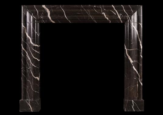 A brown marble bolection fireplace