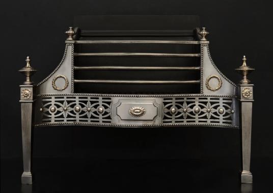 A polished steel firegrate in the George III style