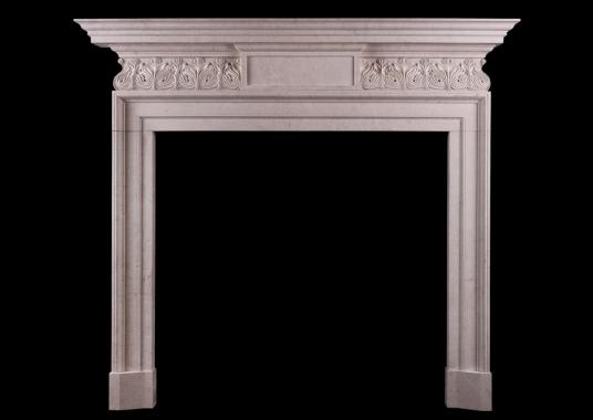 A GEORGE II STYLE STONE FIREPLACE WITH CARVED FRIEZE