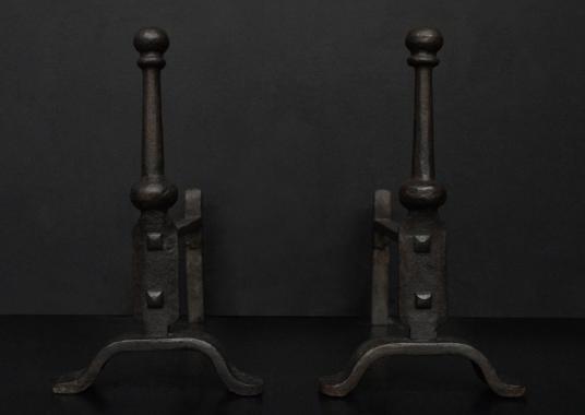 A pair of wrought iron firedogs