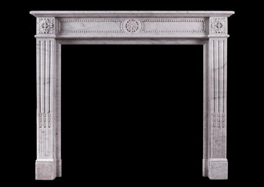 A petite French marble fireplace in the Louis XVI manner