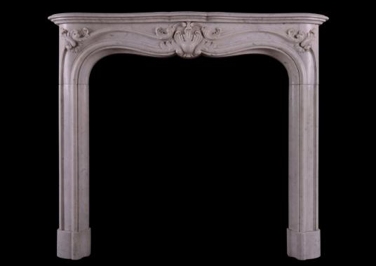 A French marble fireplace in the Louis XV manner.