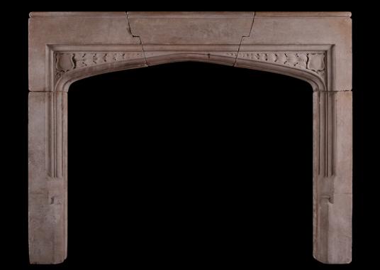 An English moulded stone fireplace in the Gothic manner