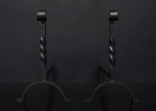 A pair of wrought iron firedogs