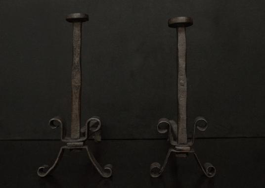 A pair of wrought iron firedogs