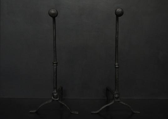 A pair of English firedogs in a black lead finish