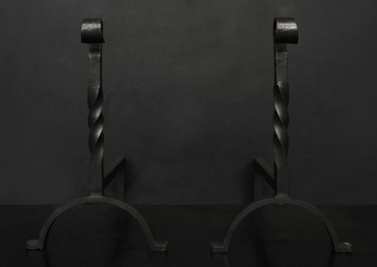 A pair of wrought iron firedogs