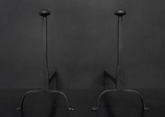 A pair of firedogs in black lead