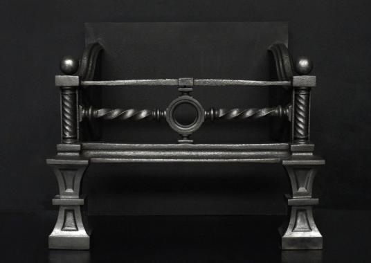 A polished cast iron firebasket in the Neo Gothic style