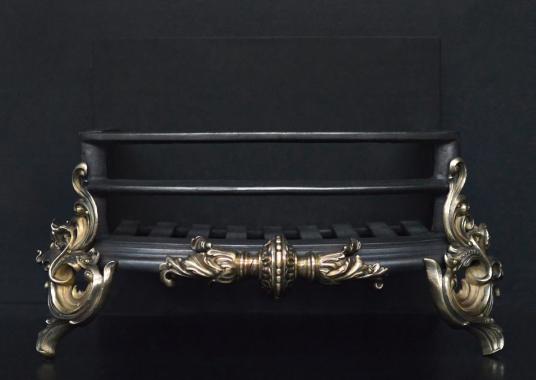 A Rococo brass and steel firegrate