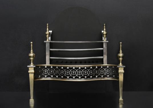 A George III style cast iron and brass firegrate