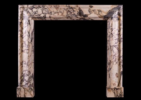 A Breche Violette marble bolection fireplace