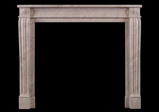 A French Louis XVI style fireplace in Italian Carrara marble