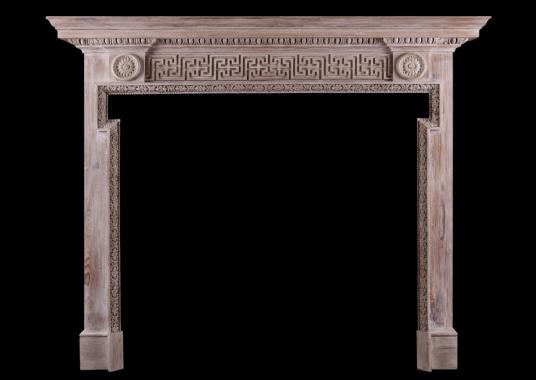 A carved pine fireplace in the George III style