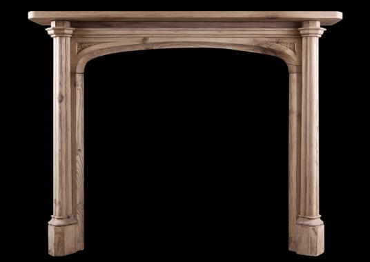 An English pine fireplace in the Gothic manner