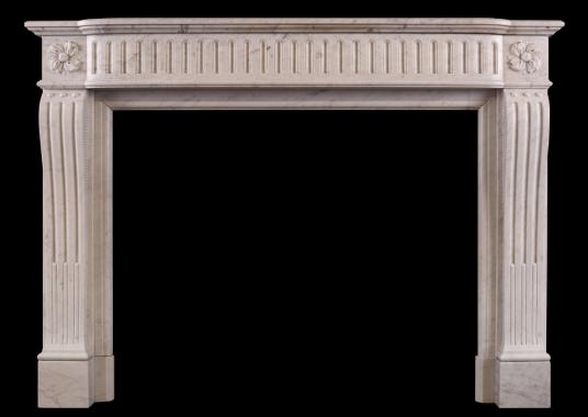 A Louis XVI style fireplace in a light Carrara marble