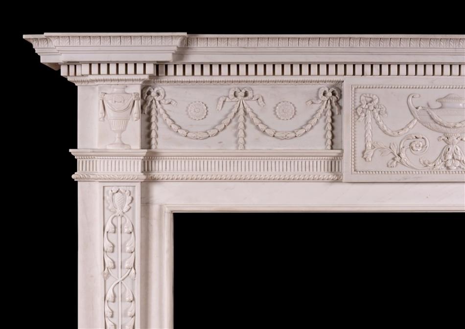 A white marble fireplace in the manner of Robert Adam