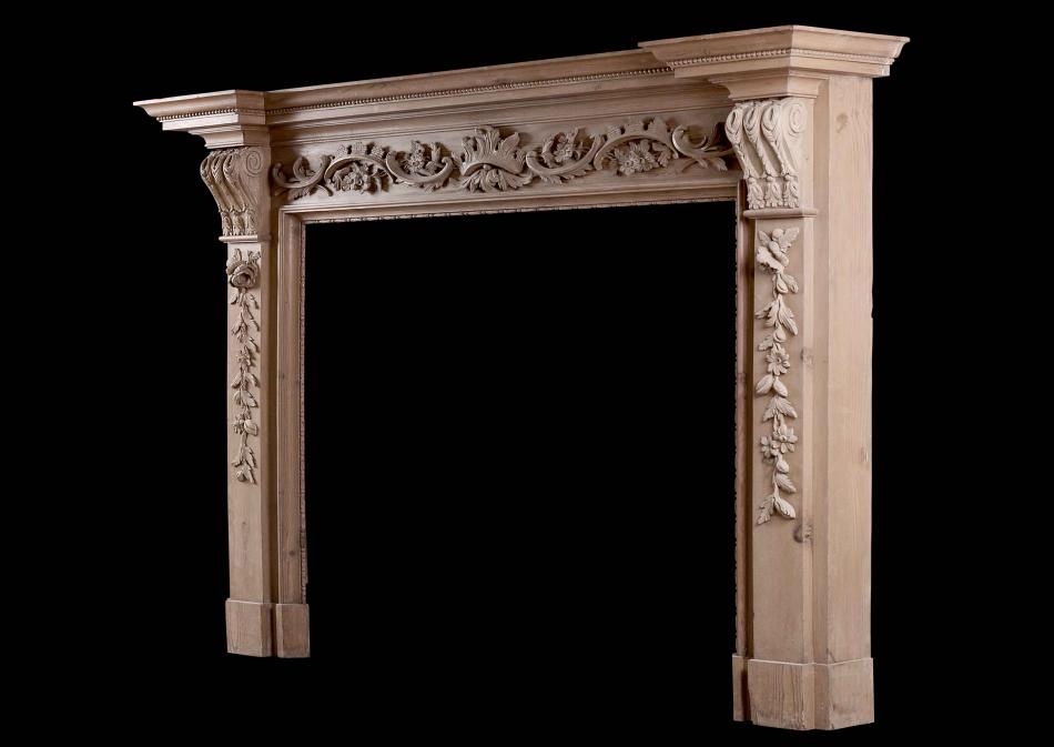 An English pine fireplace with carved fruit and foliage