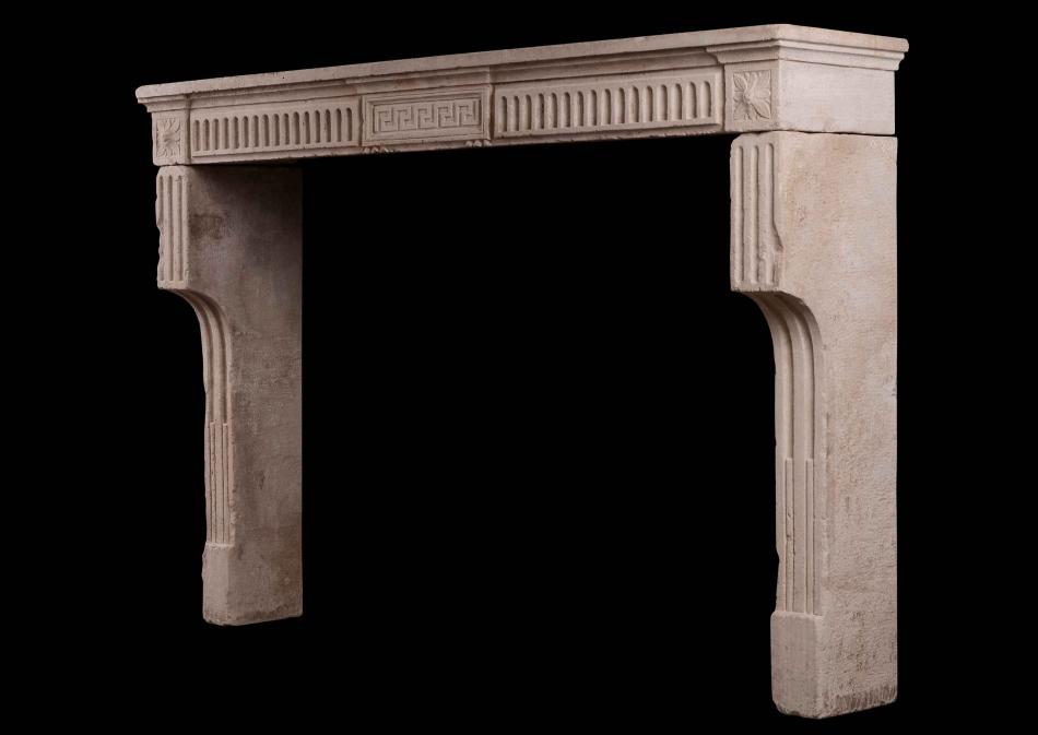 A Period 18th Century Louis XVI stone fireplace with Carved Greek Key and Fluting