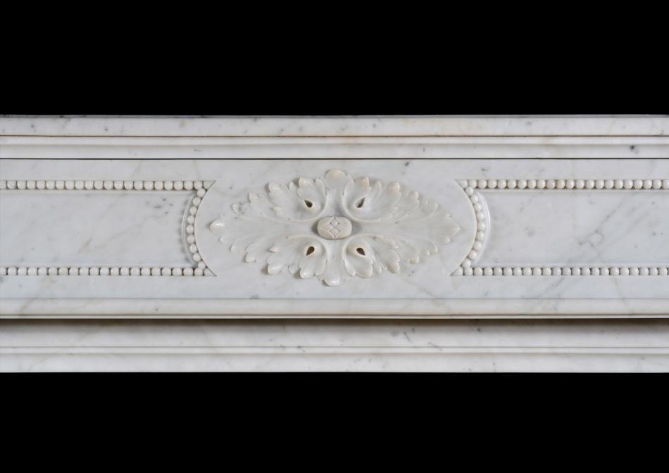 A French Louis XVI style antique fireplace in Carrara marble