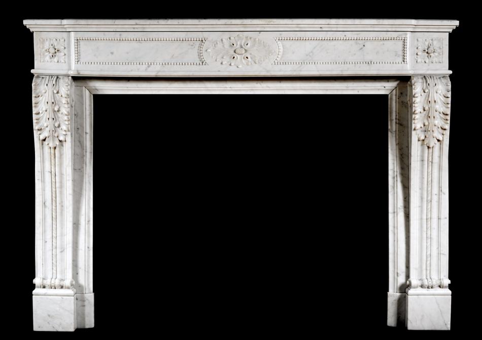 A French Louis XVI style antique fireplace in Carrara marble