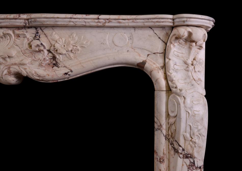 A Louis XV antique fireplace in a variegated marble