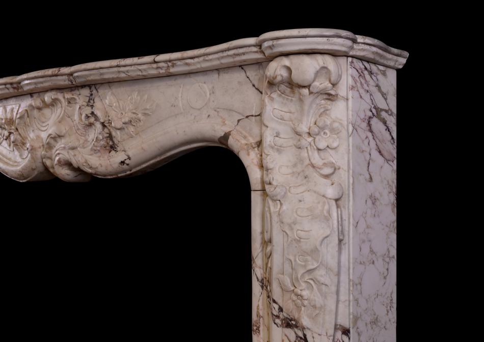 A Louis XV antique fireplace in a variegated marble