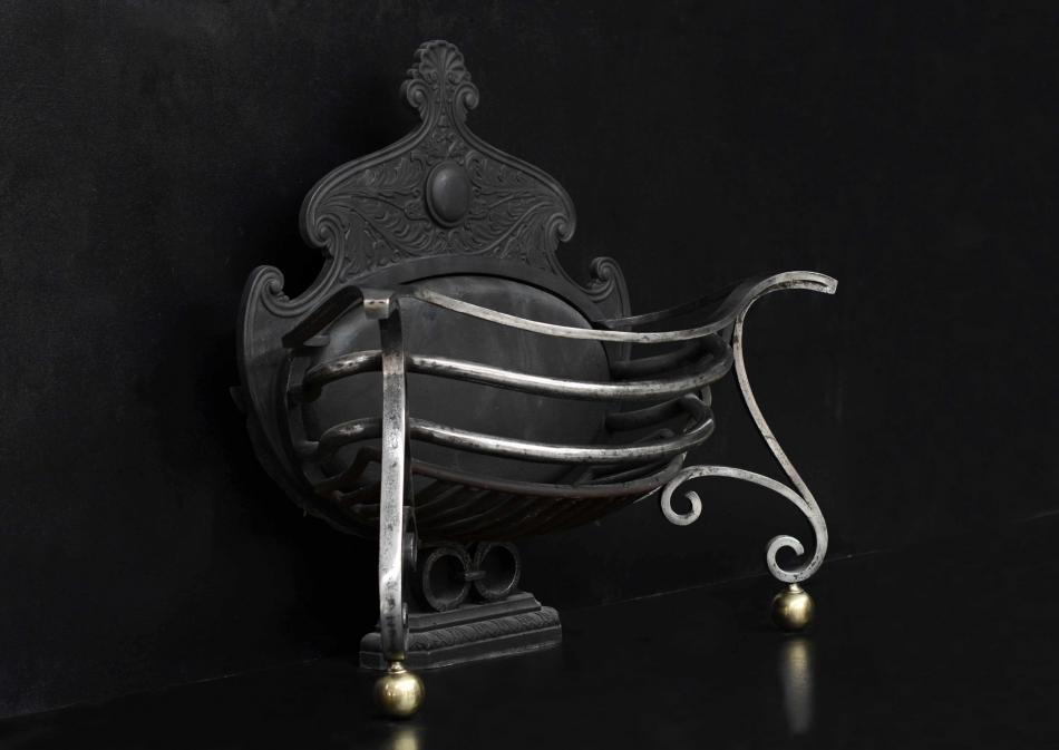 An unusual shaped Art Nouveau wrought iron firebasket