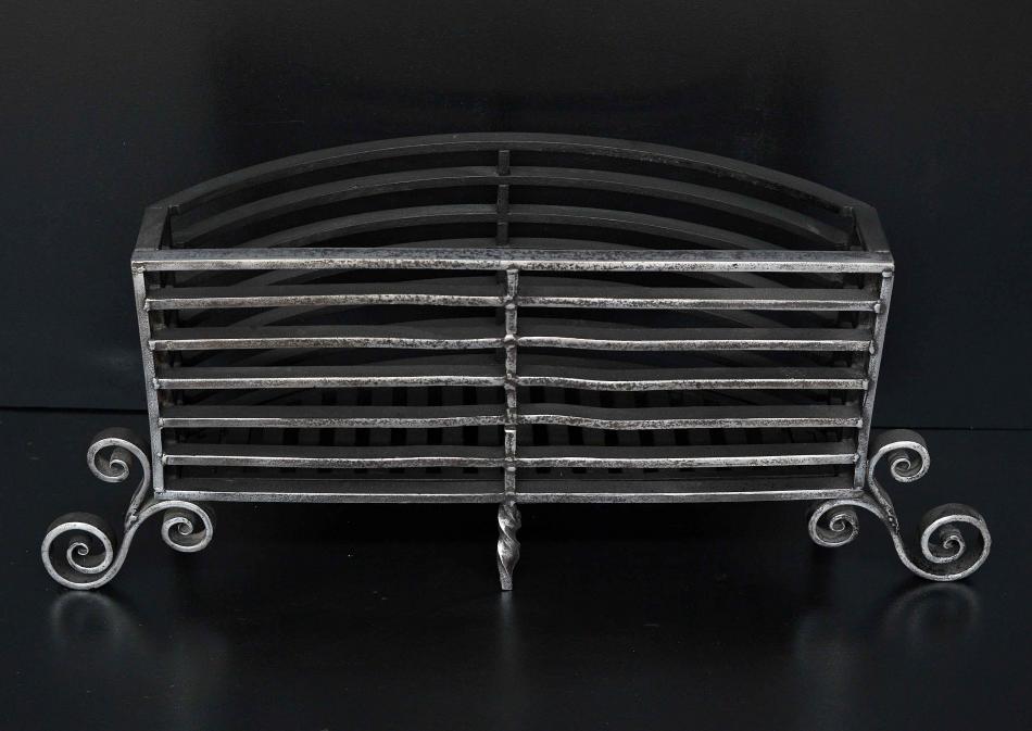 A polished Arts and Crafts wrought iron firegrate