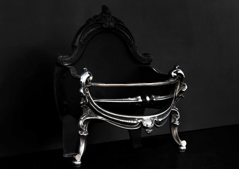 A polished cast iron firebasket in the Rococo manner