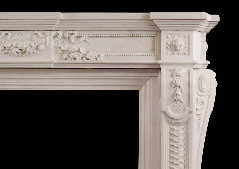 A very finely carved French Louis XVI Style Statuary Marble Fireplace