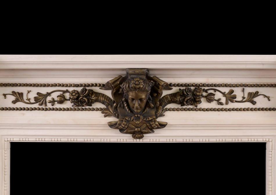A Regency Style fireplace in white marble with bronze adornments