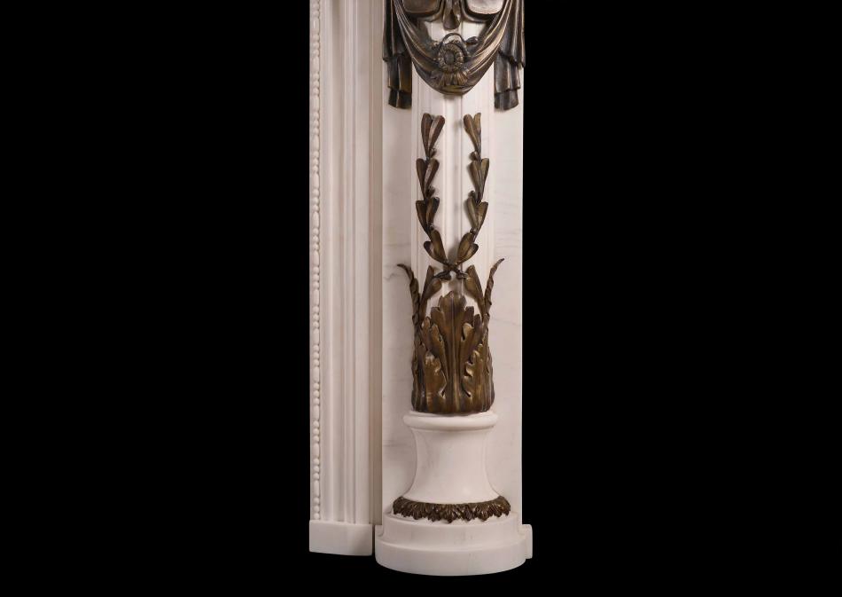 A Regency Style fireplace in white marble with bronze adornments
