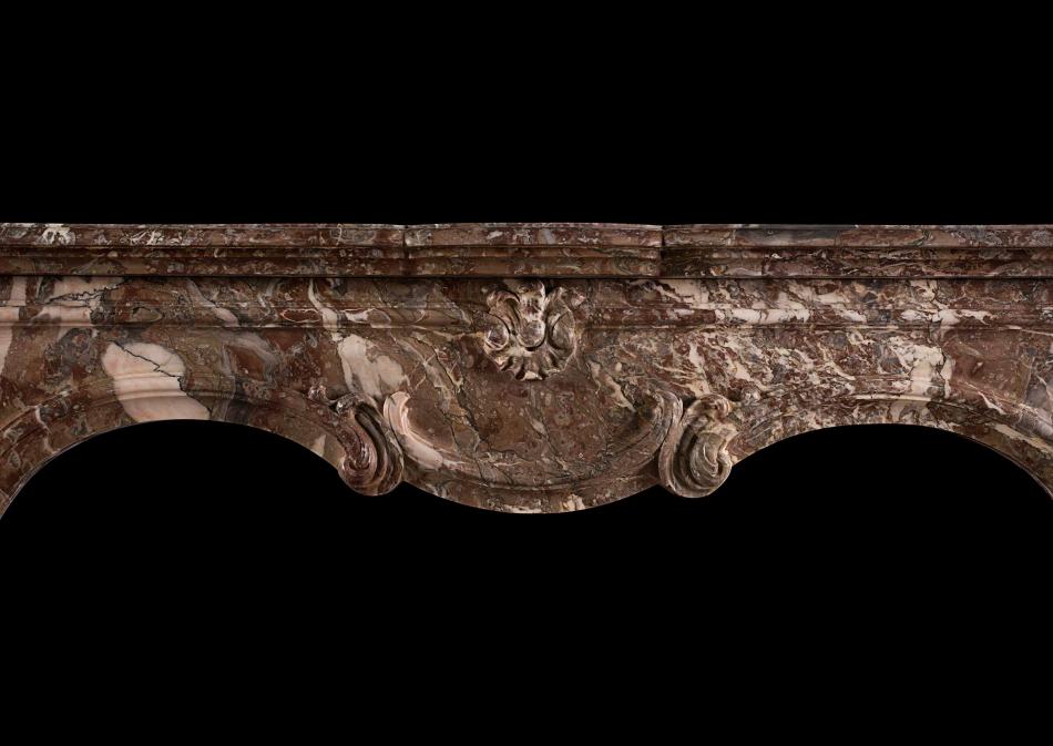 A period 18th century Louis XIV/XV transitional fireplace in Languedoc marble