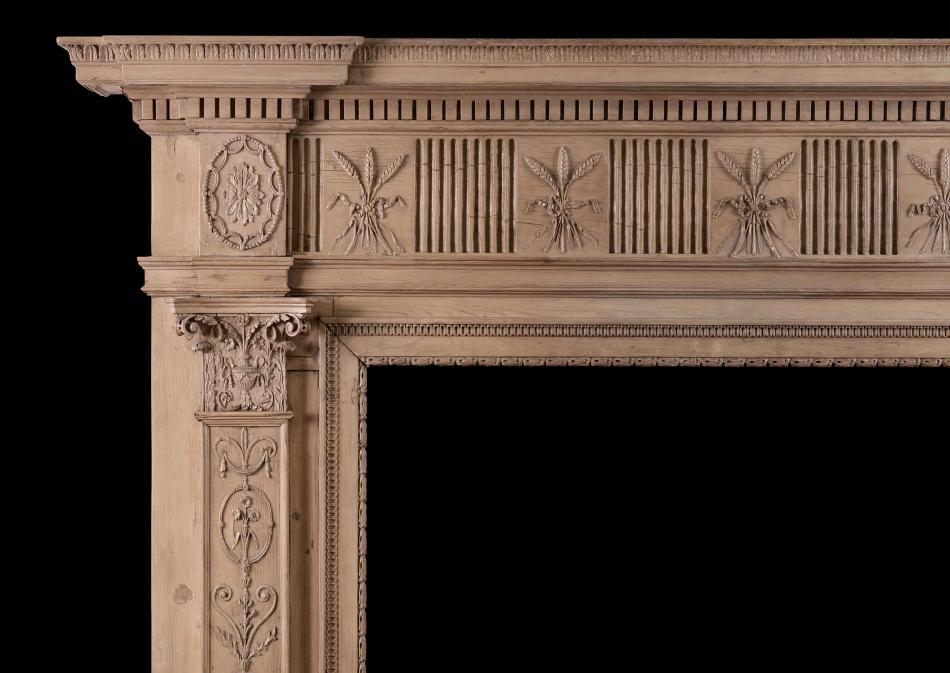 An 18th century carved pine fireplace in the Adam style