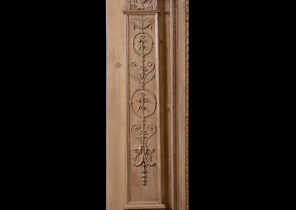 An 18th century carved pine fireplace in the Adam style