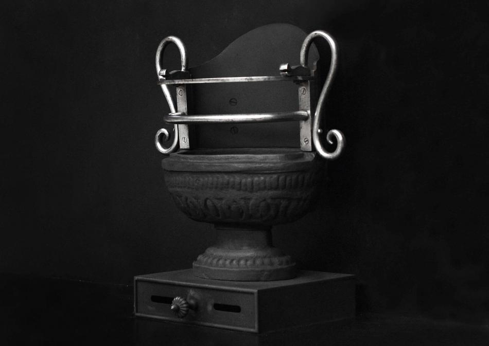 A Regency style cast iron urn grate
