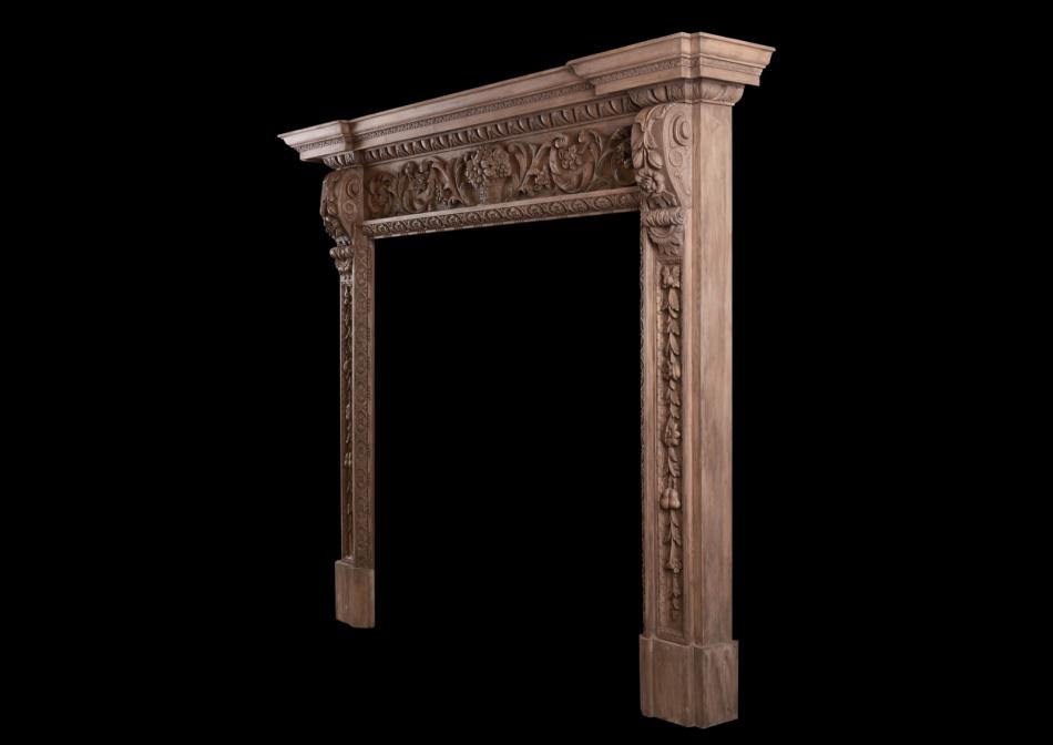 An ornate pine fireplace with carving throughout