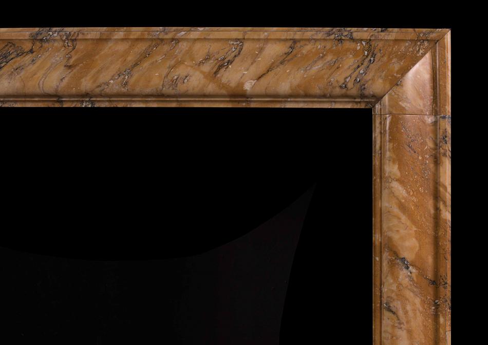 A petite Siena marble bolection fireplace
