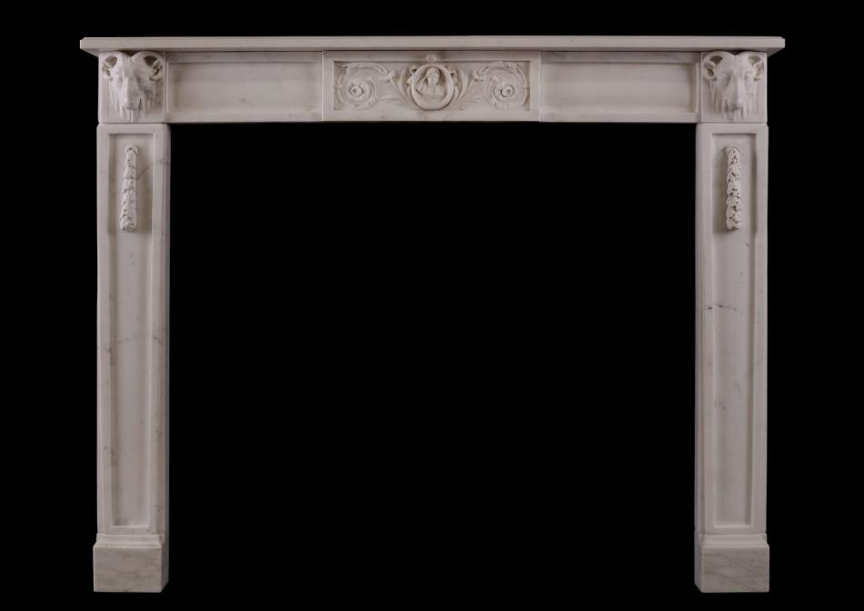 An Italian Statuario marble fireplace with carved rams heads