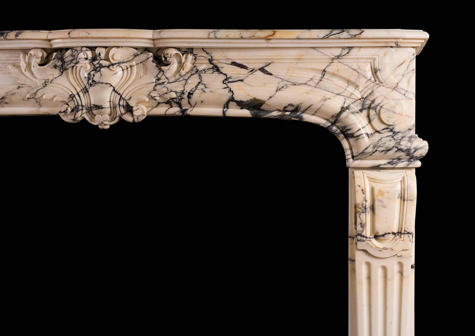 A 19th century Louis XIV / Louis XV style antique fireplace in Pavonazzo marble