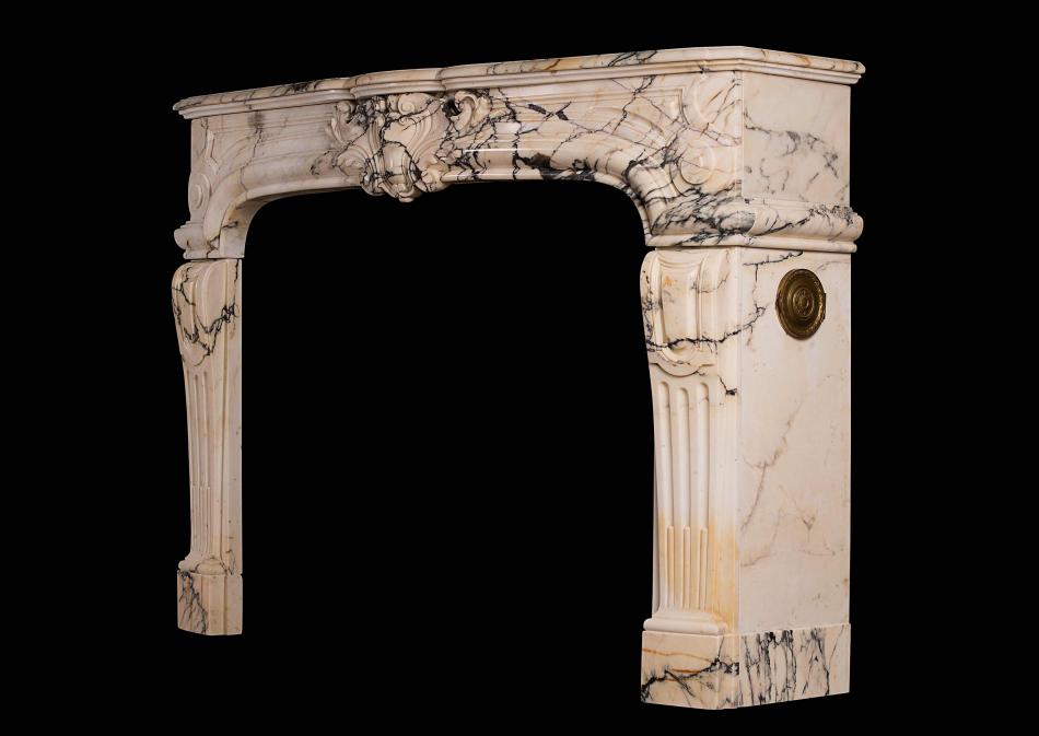 A 19th century Louis XIV / Louis XV style antique fireplace in Pavonazzo marble
