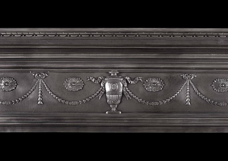 A 19th century polished cast iron fireplace in the Adam style
