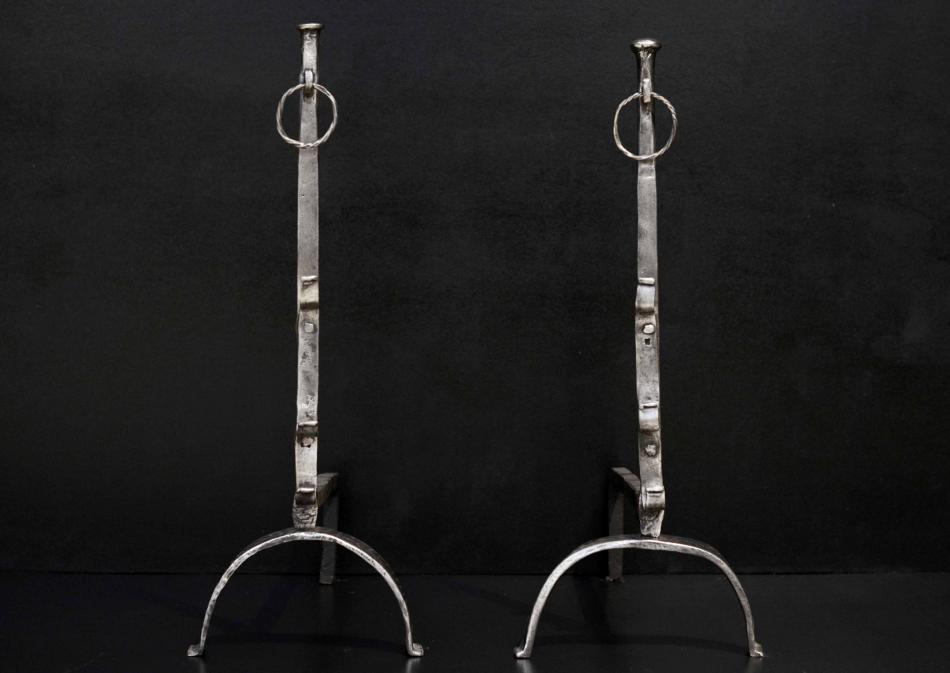 A large pair of polished wrought iron firedogs 32.5 inch
