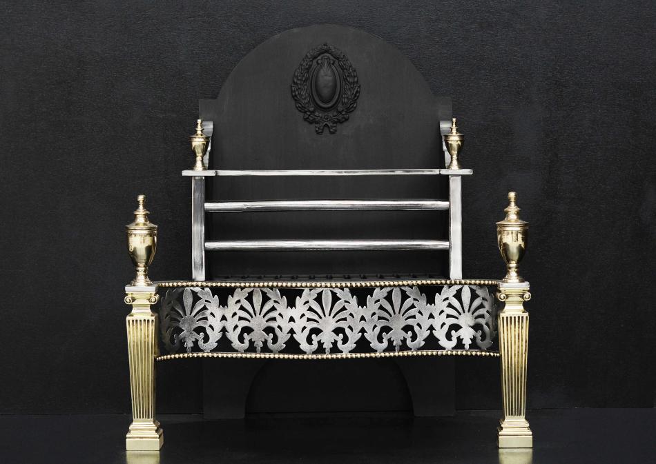 A brass and steel fire basket with Ionic capitals