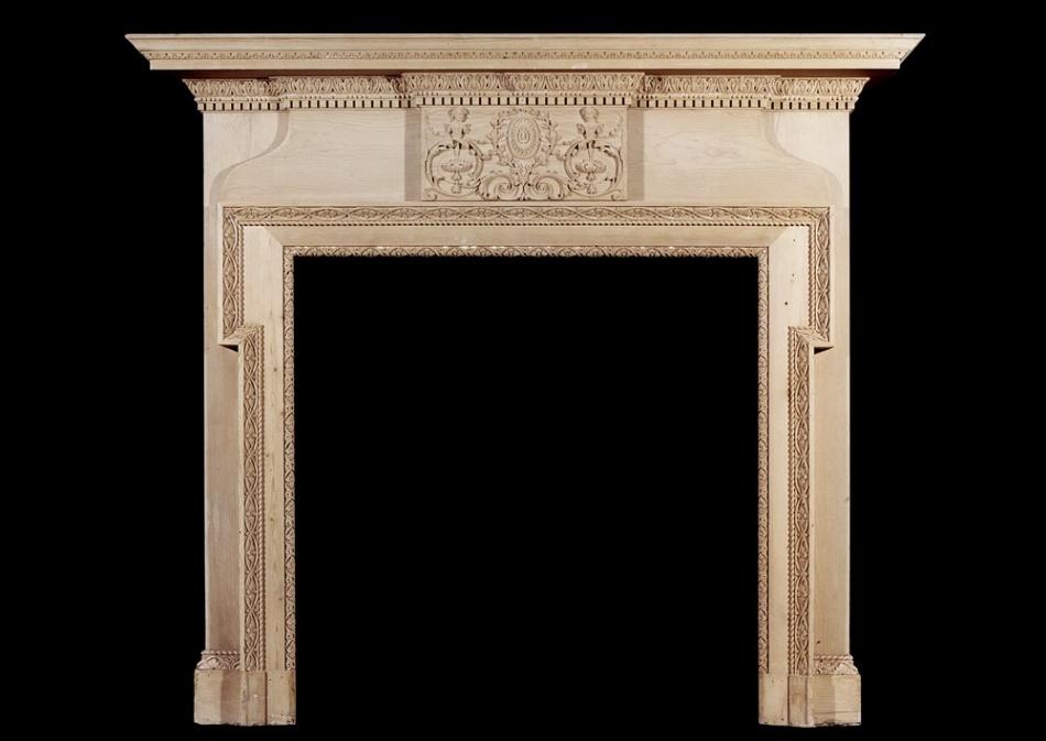A mid 19th century antique English carved pine fireplace